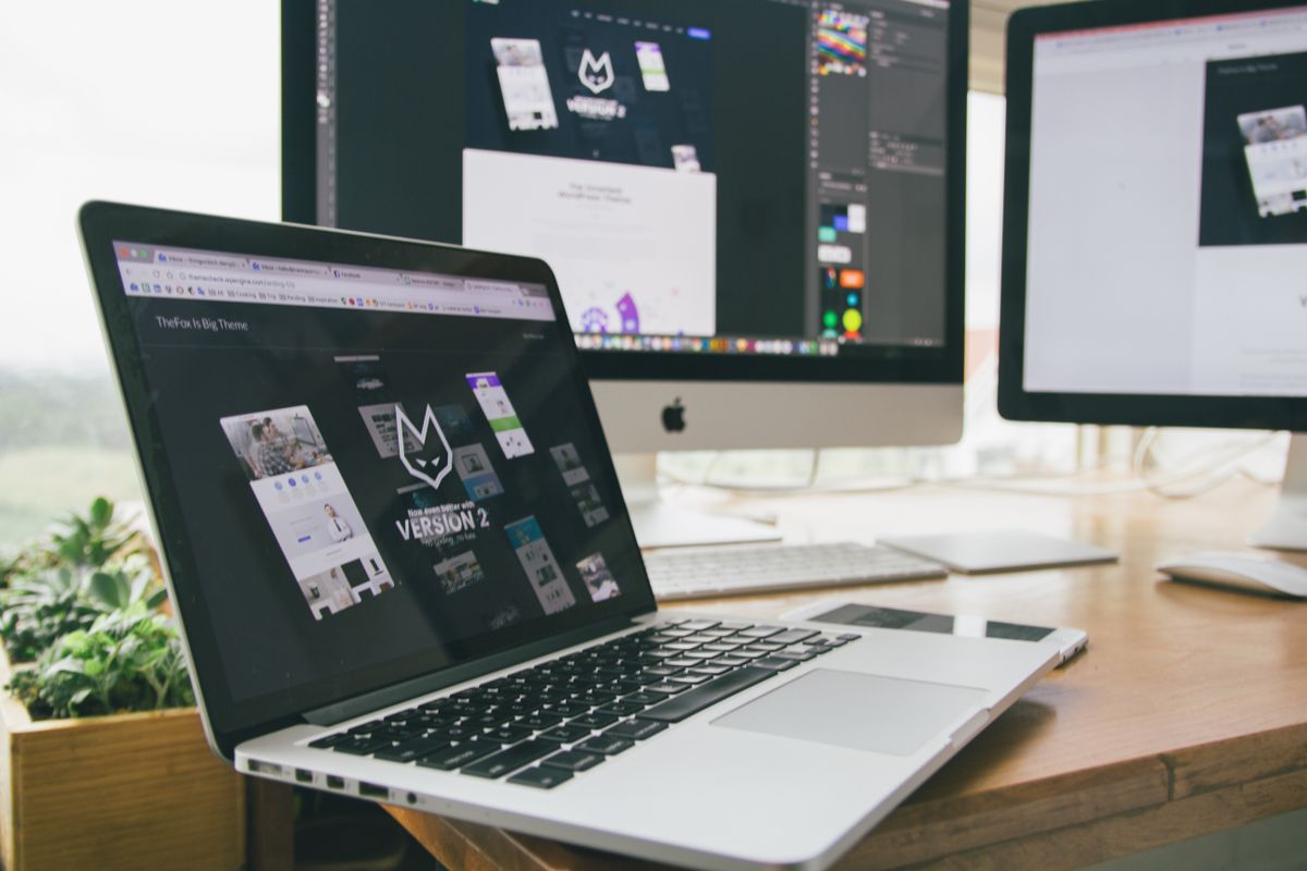 Web design workstation with multiple screens — the 40 to 80 hours behind a Swiss website quote